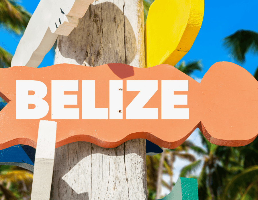 A colorful sign displaying the word "Belize" against a tropical background.